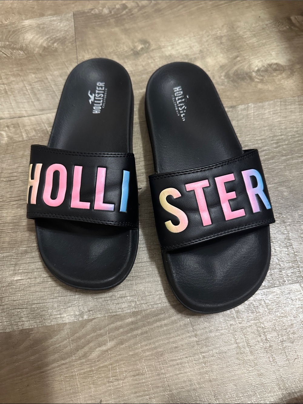 Hollister Black Slide Sandals with Pastel Rainbow Lettering
